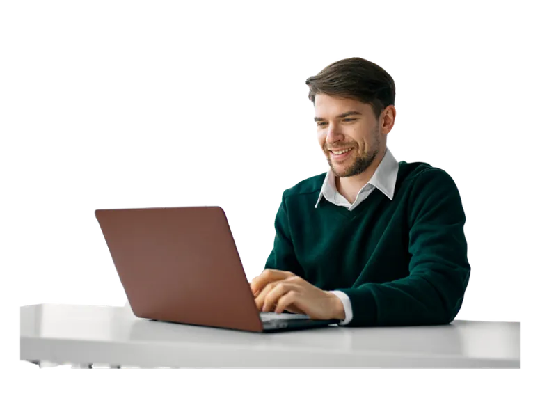 Man sitting at table with laptop smiling — Figtree Systems
